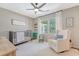 Serene Bedroom with a crib, comfortable chair, and natural light from the window at 803 Burnett Dr, Charleston, SC 29412
