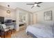 Bright bedroom with a ceiling fan, desk, chair, and mirror reflecting the bed at 803 Burnett Dr, Charleston, SC 29412
