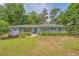 Charming single-story home features a lush front yard with beautiful landscaping and an attached garage at 803 Burnett Dr, Charleston, SC 29412