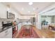 Updated kitchen features white cabinets, stainless appliances, island, and open floor plan to living space at 803 Burnett Dr, Charleston, SC 29412