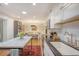 Kitchen with stainless appliances, white cabinets, subway tile backsplash, and island leading into breakfast nook at 803 Burnett Dr, Charleston, SC 29412