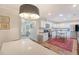 Open concept kitchen with white cabinets, stainless appliances, island, and view into the living space at 803 Burnett Dr, Charleston, SC 29412