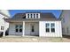 Charming single-story home with a covered porch, white siding, and a dormer window at 827 Gentle Breeze Dr, Summerville, SC 29486
