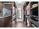 Walk-in closet with custom shelving, hanging racks, drawers, and a mirror at the end at 911 Hunt Club, Charleston, SC 29414