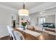 Elegant dining area boasts hardwood floors, crown molding, and access to a living room at 911 Hunt Club, Charleston, SC 29414