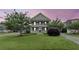 Charming two-story home features a spacious front porch, a second story balcony, and a green lawn at 911 Hunt Club, Charleston, SC 29414