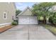 A two-car garage with white doors is shown in this home's exterior view at 911 Hunt Club, Charleston, SC 29414