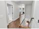 Upstairs hallway with wood floors, white doors, white trim, and staircase to the lower level at 911 Hunt Club, Charleston, SC 29414