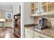 Eat in kitchen area with cabinets, granite countertops, coffee station, and pantry with wood floors at 911 Hunt Club, Charleston, SC 29414