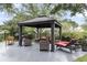 Outdoor gazebo with seating and a grill offers an inviting space for entertaining guests in a backyard setting at 911 Hunt Club, Charleston, SC 29414