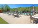 Community pool featuring lounge chairs, tables with umbrellas, and pristine landscaping around the pool deck at 911 Hunt Club, Charleston, SC 29414