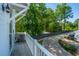 View from balcony with white railings overlooking the private neighborhood street and lush greenery at 977 Warrick Oaks Ln, Mount Pleasant, SC 29464