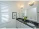 Bright bathroom with a double vanity, granite countertop, and shuttered window for ample lighting at 977 Warrick Oaks Ln, Mount Pleasant, SC 29464