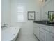 Bathroom featuring a freestanding tub, double vanity, shuttered window, and marble tile floors at 977 Warrick Oaks Ln, Mount Pleasant, SC 29464