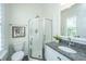 Well-lit bathroom with a glass door shower, granite countertop vanity, and leafy window at 977 Warrick Oaks Ln, Mount Pleasant, SC 29464