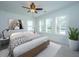 Bright bedroom featuring a ceiling fan, light walls, white trim, and plantation shutters at 977 Warrick Oaks Ln, Mount Pleasant, SC 29464
