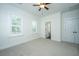 Bright bedroom with two large windows, a ceiling fan, and an attached bathroom and closet at 977 Warrick Oaks Ln, Mount Pleasant, SC 29464