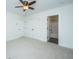 Neutral bedroom featuring 2 closets, ceiling fan, light walls, white trim, and en suite bathroom at 977 Warrick Oaks Ln, Mount Pleasant, SC 29464