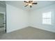 Empty bedroom featuring a ceiling fan, neutral carpet, and large window at 977 Warrick Oaks Ln, Mount Pleasant, SC 29464