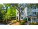 Stunning house with traditional siding, mature trees, and manicured landscaping, creating inviting curb appeal at 977 Warrick Oaks Ln, Mount Pleasant, SC 29464