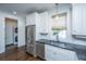 Modern kitchen with stainless steel appliances, granite countertops, and white cabinets at 977 Warrick Oaks Ln, Mount Pleasant, SC 29464