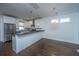 Eat-in kitchen with stainless steel appliances, granite countertops, white cabinets, and hardwood floors at 977 Warrick Oaks Ln, Mount Pleasant, SC 29464