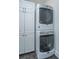 Efficient laundry area equipped with stacked washer and dryer units and ample cabinet storage at 977 Warrick Oaks Ln, Mount Pleasant, SC 29464