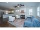 Cozy living room featuring a fireplace, hardwood floors, and plenty of natural light at 977 Warrick Oaks Ln, Mount Pleasant, SC 29464
