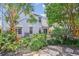 Spacious backyard showcasing the home's exterior, lush landscaping, and a serene outdoor ambiance with mature palms and trees at 1007 Whitlow Blvd, Summerville, SC 29483