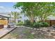 Charming backyard features lush greenery, stone pathway, deck, and inviting egg chair for relaxed outdoor living at 1007 Whitlow Blvd, Summerville, SC 29483