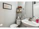 Cozy powder room featuring a stylish vanity, decorative shelves, and elegant fixtures at 1007 Whitlow Blvd, Summerville, SC 29483