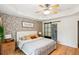 Comfortable bedroom features tray ceiling, ceiling fan, and ensuite bath with sliding glass door at 1007 Whitlow Blvd, Summerville, SC 29483