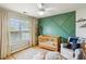 Bedroom featuring accent wall, crib, and window with natural light at 1007 Whitlow Blvd, Summerville, SC 29483