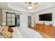 Spacious main bedroom featuring tray ceilings, barn door to bathroom, and wood floors at 1007 Whitlow Blvd, Summerville, SC 29483