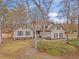 Two-story home with neutral siding, black shutters, brick foundation, mature trees, and a well-maintained lawn at 101 Plantation Dr, Summerville, SC 29485