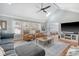 Spacious living room with vaulted ceiling, skylight, plush seating, and ample natural light at 101 Plantation Dr, Summerville, SC 29485