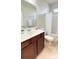 Well-lit bathroom features a vanity with a white countertop and cherry wood cabinetry plus tile floors at 115 Hyrne Dr, Goose Creek, SC 29445