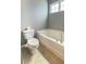 Bathroom with toilet and bathtub, with neutral tile flooring and a window for natural light at 115 Hyrne Dr, Goose Creek, SC 29445