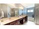 Bright bathroom with double vanity, shower, and bathtub, featuring a large mirror and neutral color palette at 115 Hyrne Dr, Goose Creek, SC 29445