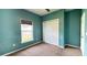 Carpeted bedroom with blue walls and a window; the room also contains a closet at 115 Hyrne Dr, Goose Creek, SC 29445
