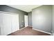 Bedroom with large closet doors, gray walls, carpet flooring, and white trim and doors at 115 Hyrne Dr, Goose Creek, SC 29445