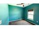 Cozy bedroom features a ceiling fan, a window, and carpeted flooring with blue walls at 115 Hyrne Dr, Goose Creek, SC 29445