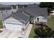 Aerial shot of a house with a two-car garage, stone accents, and well-kept landscaping at 115 Hyrne Dr, Goose Creek, SC 29445