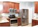 Well-equipped kitchen featuring stainless steel appliances, rich wood cabinetry, and granite counters at 115 Hyrne Dr, Goose Creek, SC 29445