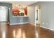 Spacious living room showcasing hardwood floors and a view of the kitchen with stainless appliances at 115 Hyrne Dr, Goose Creek, SC 29445