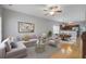 Open-concept living room boasts stylish furniture, a ceiling fan, and seamless flow into the dining area and kitchen at 116 Venezia Ct, Ladson, SC 29456