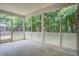 Spacious screened porch with lattice detailing and view of wooded backyard at 116 Venezia Ct, Ladson, SC 29456