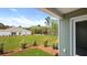This backyard features an expansive lawn with tasteful landscaping and an airy, covered patio area at 117 Mims Academy Dr, Harleyville, SC 29448