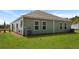 This backyard features siding, windows, well-maintained landscaping, a lawn, and an external HVAC unit at 117 Mims Academy Dr, Harleyville, SC 29448