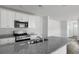 Modern kitchen with granite countertops, stainless steel appliances, and white cabinetry at 117 Mims Academy Dr, Harleyville, SC 29448